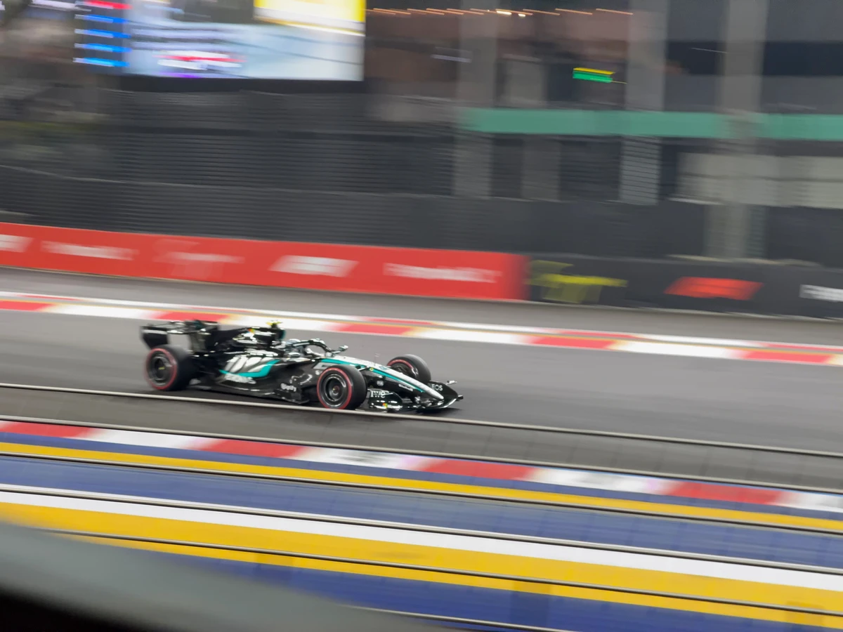 A race car panned with VelocityLens on iPhone, against a streaked background.
