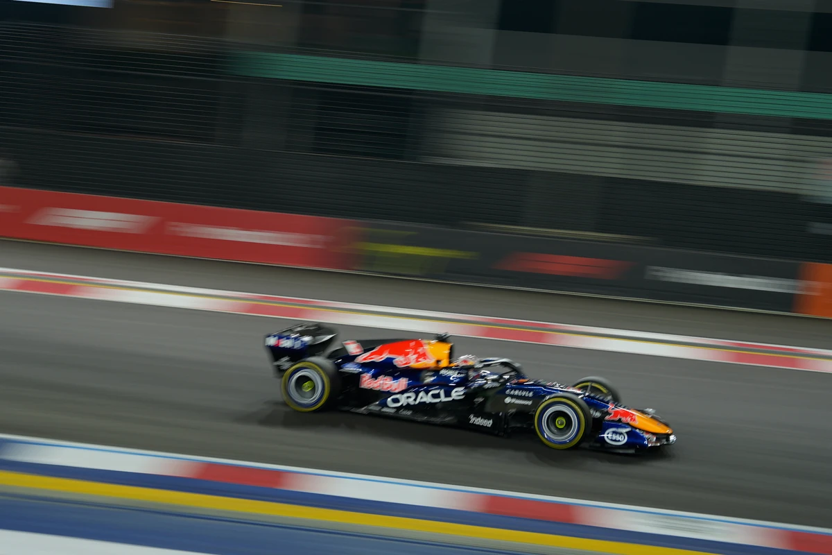Red Bull in profile at night with blurred barriers at the Singapore GP