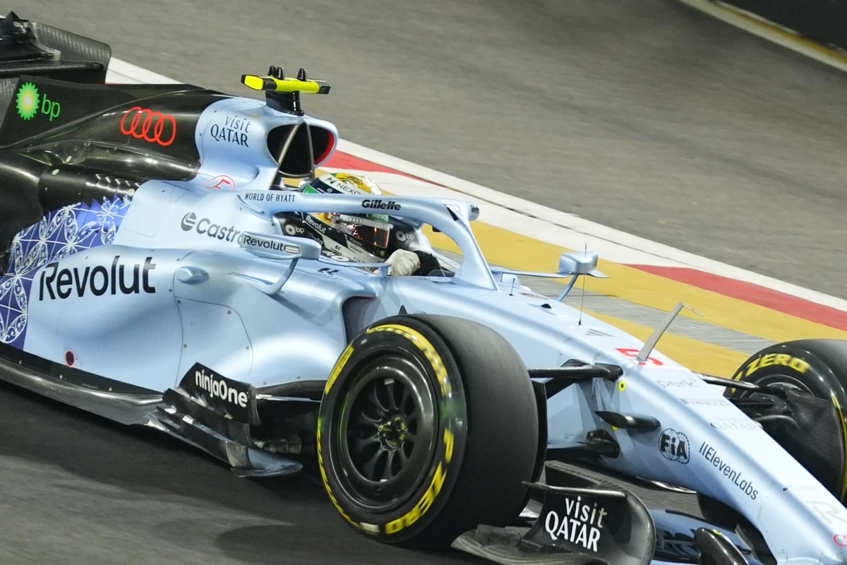 Close-up of an Audi cockpit and yellow-marked front tyre under Singapore GP floodlights